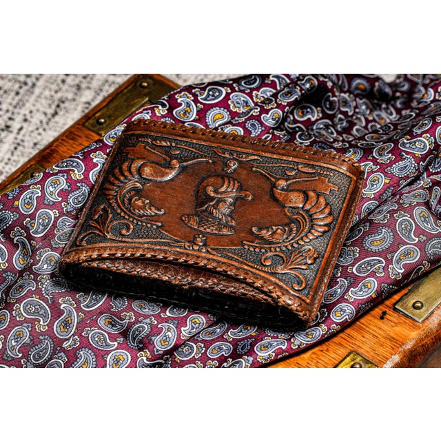 A striking example of early 20th-century craftsmanship, this antique leather cigarette case radiates timeless...