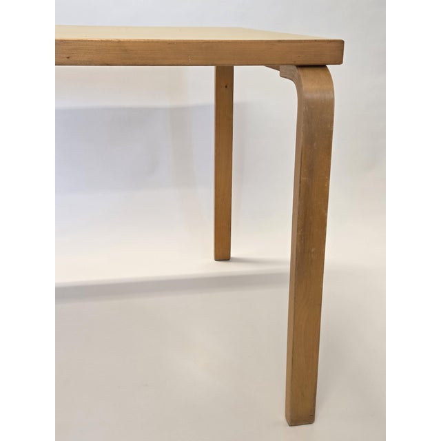 Artek 81B table, birch with yellow linoleum. Designer Alvar Aalto. The table is from around the 1950s/60s. The table has...