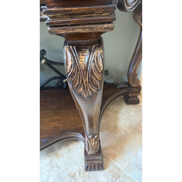 An impressive and richly detailed console table by Marge Carson, crafted in the Spanish Revival style. This elegant piece...