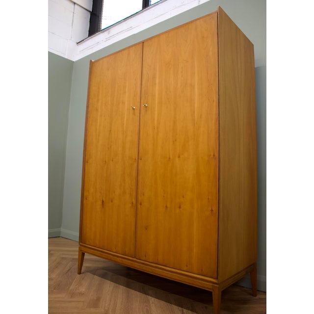 A stylish mid-century double wardrobe by McIntosh Furniture, dating from the 1960s. Crafted in beautifully figured teak...