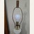 This is a tall 1970s Mid-Century Modern white ribbed ceramic table lamp with a dark wood base, brass-tone hardware, and a...