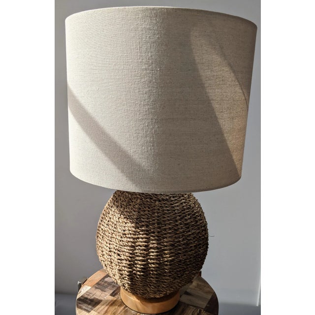 Buckle up for some serious coastal style with this organic modern natural woven rattan table lamp. Hold a standard...