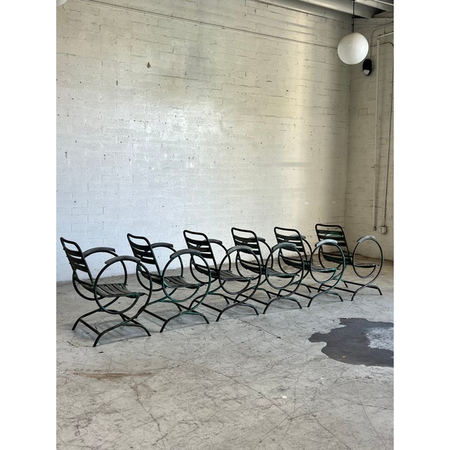 Beautifully patina'd metal and slatted wood garden chairs. This set features a cantilever base with springer action,...
