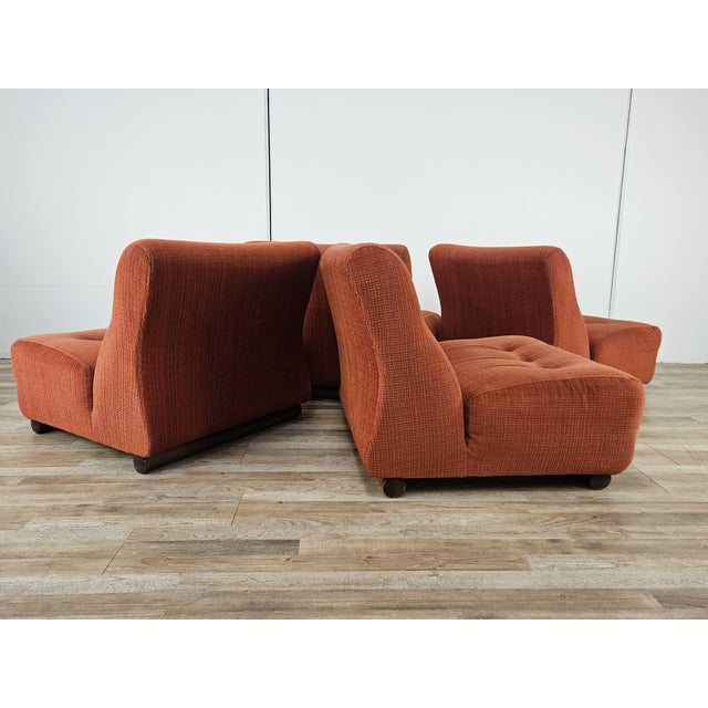 Set of four 1970s-style armchairs upholstered in vibrant red fabric, perfect for making any room unique. Note the...