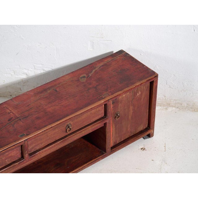 Antique low sideboard in pine wood, chinese provincial furniture with vermilion lacquer originating from gansu and dated...