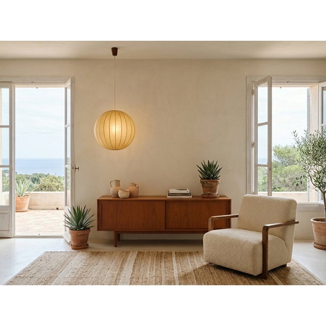 This 1970s pendant lamp is a quintessential example of the "Cocoon" technique, an innovative process where synthetic resin...