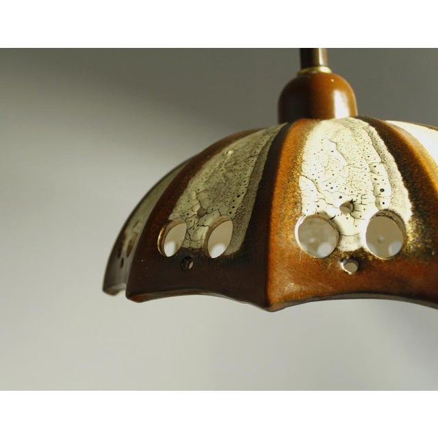 Adjustable fat lava ceramic pendant light from the 1970s. It is in very good working condition, labeled with Pan. This...