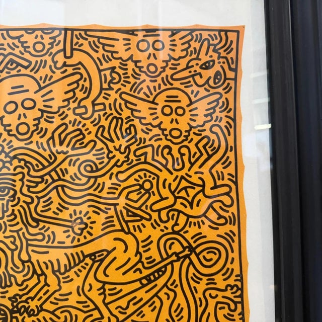 This 21st-century framed lithography is a striking example of Keith Haring’s iconic Pop Art style, characterized by his...