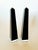 A striking pair of modern black lucite obelisks set on clear lucite platforms. This stunning set has a glossy finish and a...