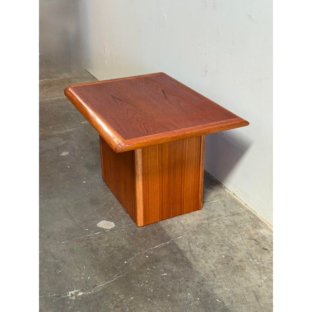Danish teak side table, a stunning example of mid-century modern design. Made in Denmark and dating back to the 1960s,...