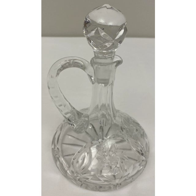 Elegant Early 20th century French Art Deco style crystal oil and vinegar cruets or serving bottles in cut crystal with an...