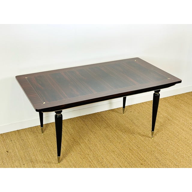 An elegant rectangular table with a Macassar ebony top dating from the 1940s, enhanced by beautiful visible grain and...