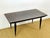 An elegant rectangular table with a Macassar ebony top dating from the 1940s, enhanced by beautiful visible grain and...