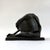 A modernist bronze sculpture depicting a seated abstract figure embracing a rounded vessel form. The simplified anatomy...