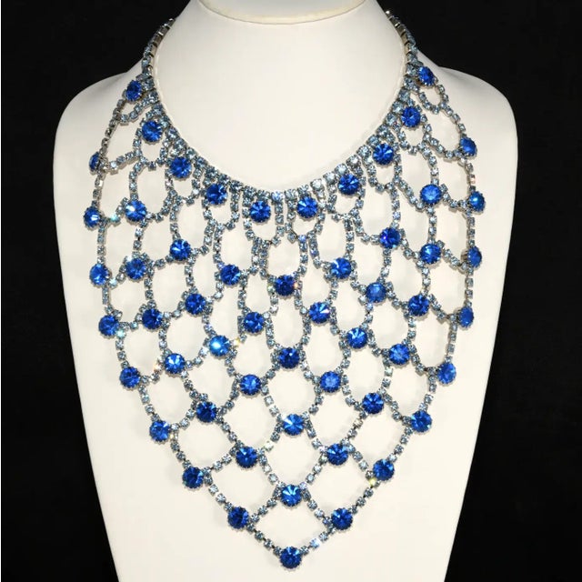 This is part of Chairish’s Costume Jewelry assortment. Dominique extra large bib necklace comprised of light and royal...
