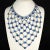 This is part of Chairish’s Costume Jewelry assortment. Dominique extra large bib necklace comprised of light and royal...