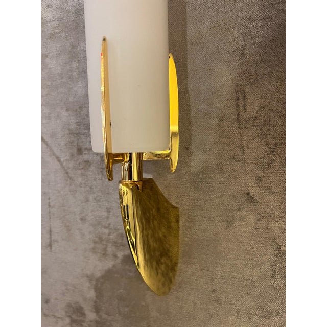 A pair of luxurious 1990s gold plated wall lights with white cylinder shades. Rewired.Made by the Austrian lighomaler,...