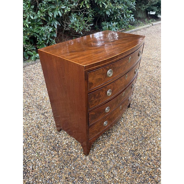 19th Century Georgian Mahogany Bow Fronted Chest of Drawers, with four long graduated oak lined drawers with brass ring...