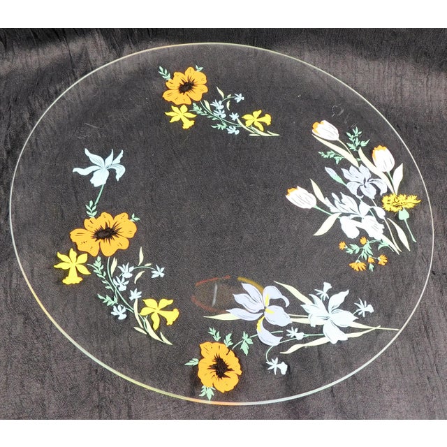 This is a round, clear glass serving tray by Heinrich & Co. in the Primavera pattern from 1977. The tray is clear glass...