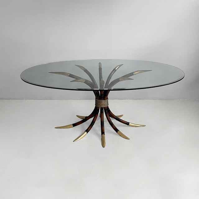 Italian modern oval table in bamboo, brass and glass, 1980s Dining table with an oval clear glass top. The base is made of...