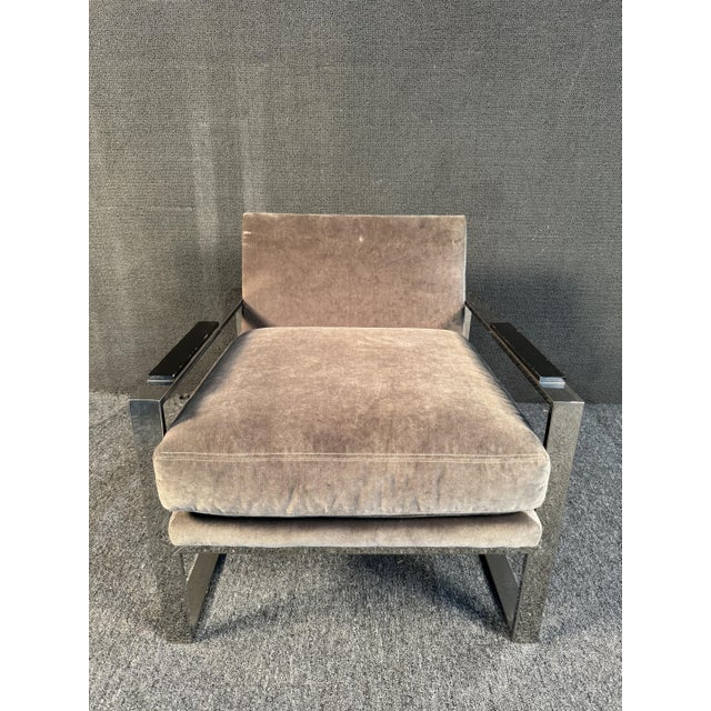 Sleek chrome lounge chair by Michael Weiss featuring wood arm rests and comfortable grey upholstery. Dimensions...