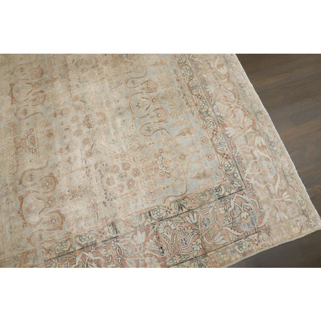 an early 20th-century Persian Kerman washed out floral motif rug