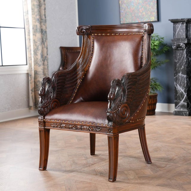 This high end Leather Swan Arm Chair from Niagara Furniture is impressive with solid mahogany hand carved details as well...