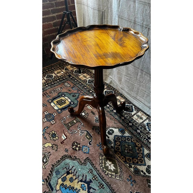 Introducing a unique occasional table with a hand-carved pie crust wine design, complete with a fluted column and tripod...