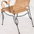 Incredible pair of armchairs in woven wicker and blackened iron. The iron frame has a free-form, organic shape, and the...