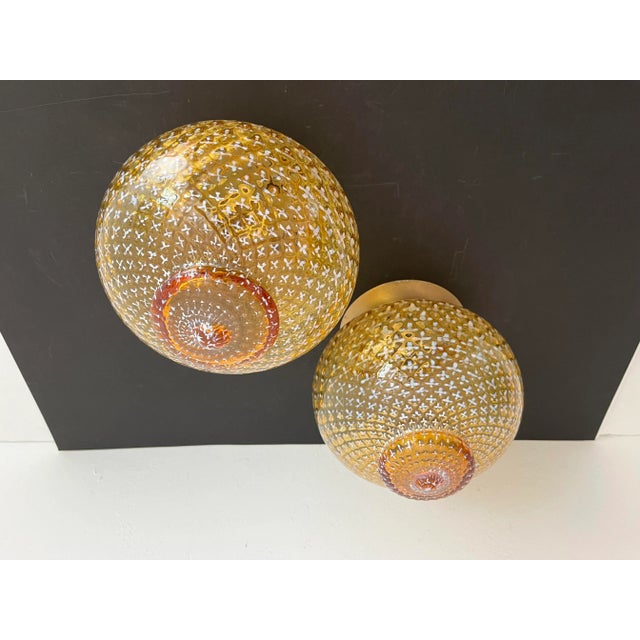Stunning hard to find pair of flush mount ceiling or wall lights by Lightolier with quilted and embossed honey gold glass...