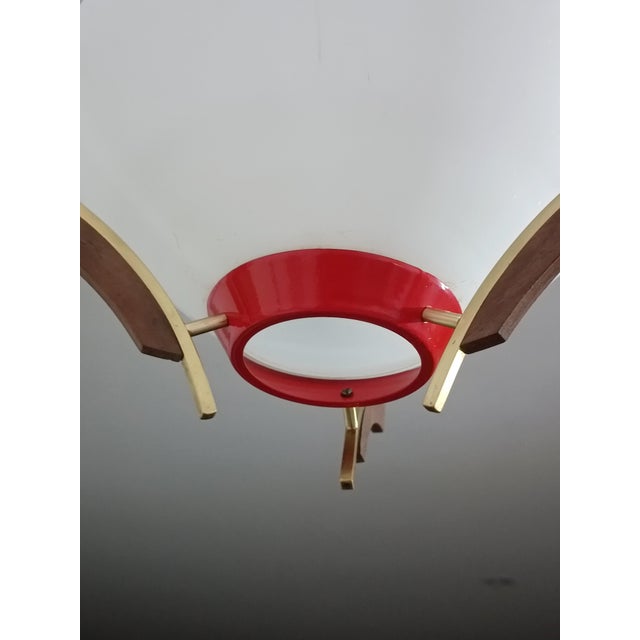 Magnificent pendant lamp in the style of Svend Aage Holm Sorensen. Denmark, 1960s. Red lacquered metal frame. Bentwood and...