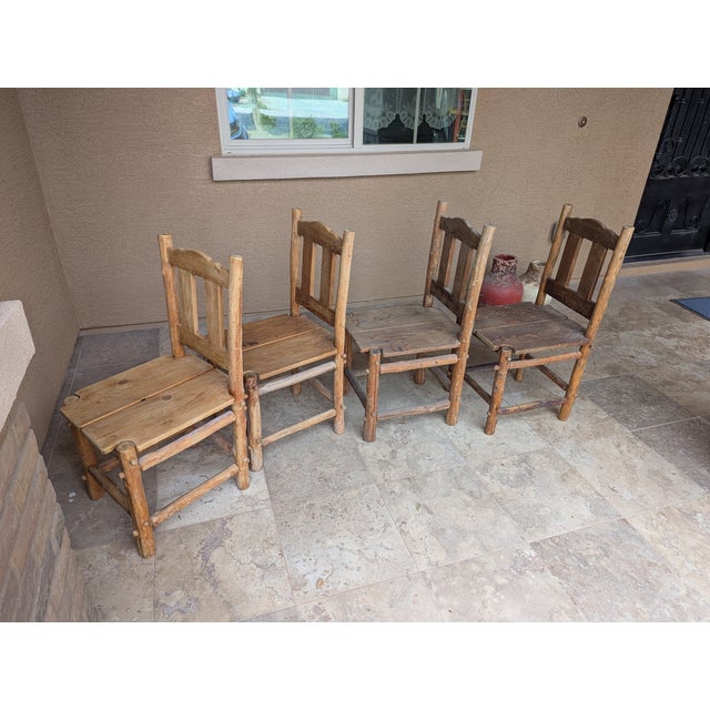 Set of 4. Two chairs on the left have a lighter stain, two on the right have a darker stain. No markings on the chairs to...