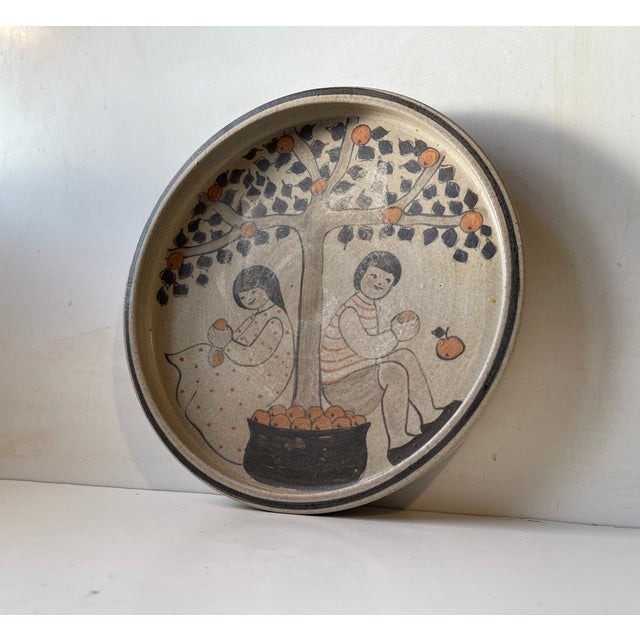 A rare stoneware dish or flat bowl from the workshop of herman august kähler. It features a rather naive scene with...