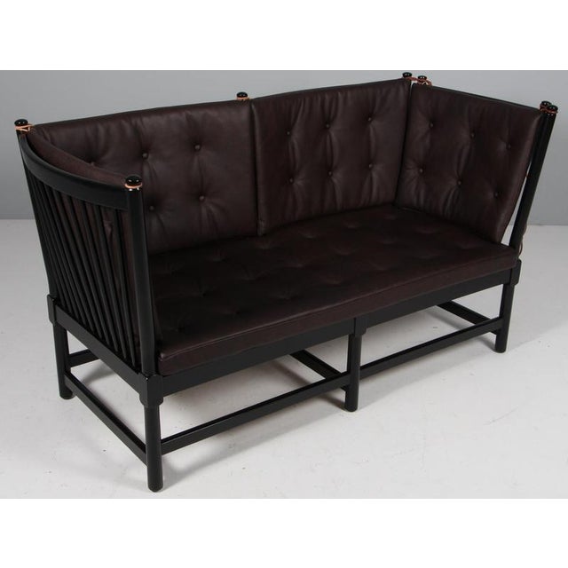 Børge Mogensen two-seat sofa in black lacquered beech and new upholstered cushions of mokka full grain aniline leather....