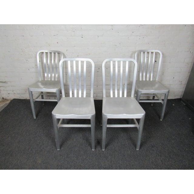 An eye-catching set of four metal dining chairs that are a versatile and bold addition to any dining room. WEAR Minor wear...