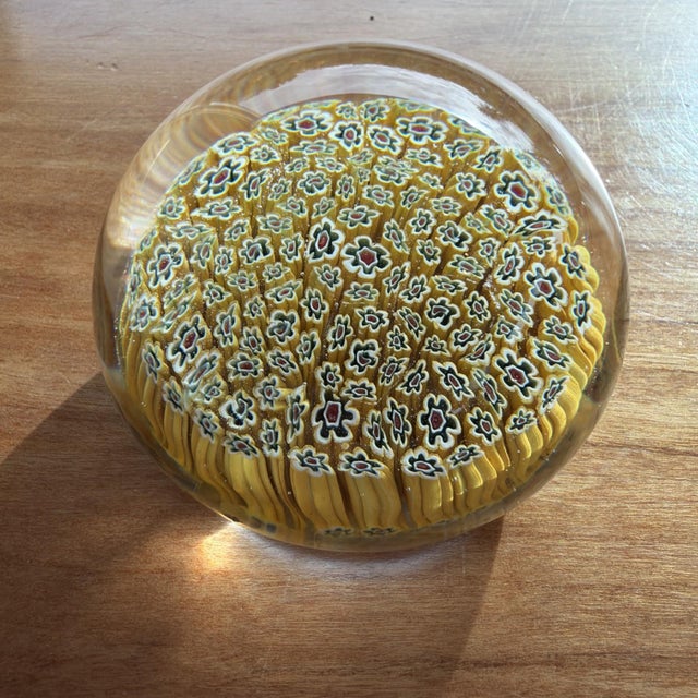 This vintage Murano yellow multicolored Millefiori glass paperweight, measuring 2.5 inches, is a beautiful piece of art...