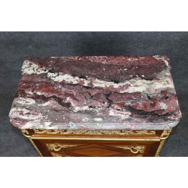 This magnificent pair of French gilt-bronze-mounted marquetry commodes by Paul Sormani exemplifies the exceptional quality...