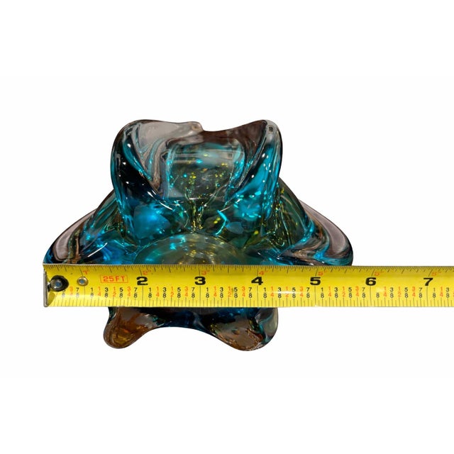 This vintage Murano-style hand-blown art glass vase features a striking tri-color palette of amber, teal, and clear...