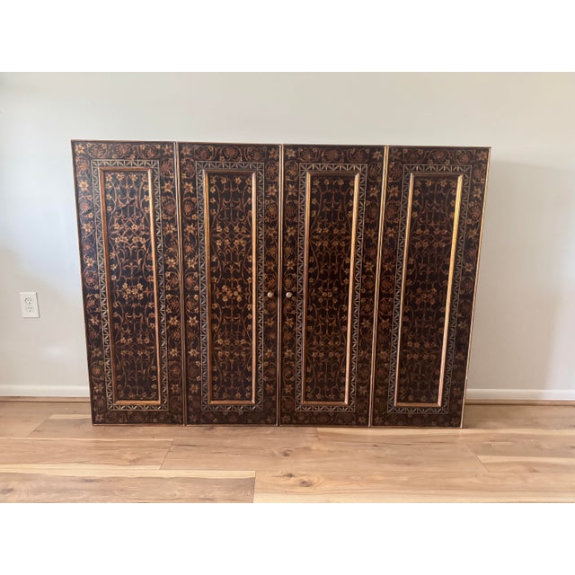 Suitable as concealed media cabinet or decorative wall installation Ebonized case with gilt foliate and geometric inlay...