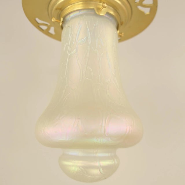 Master piece of the Viennese workshops. Solid brass ceiling lamp with iris Lötz window glass shade around 1920. Glass...