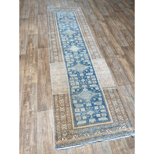 A lovely antique Serab Runner. This runner offers a blue palette with green, brown, and blush accents.