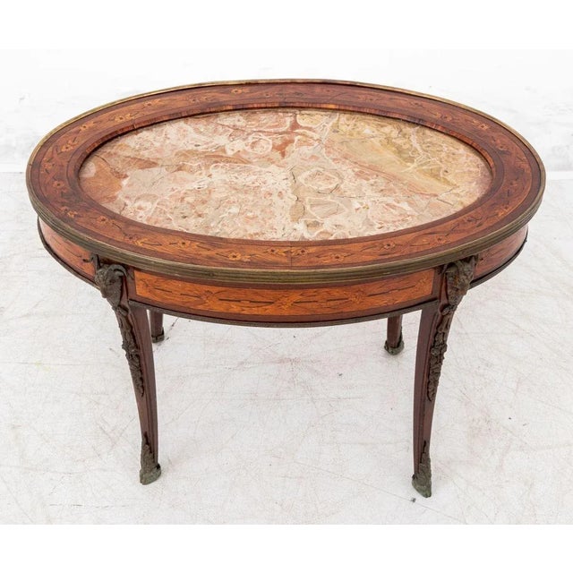 Louis XV Style Gilt Metal Mounted Kingwood and Marquetry Marble Top Oval Coffee Table, early 20th century. 20.25" H x 30"...