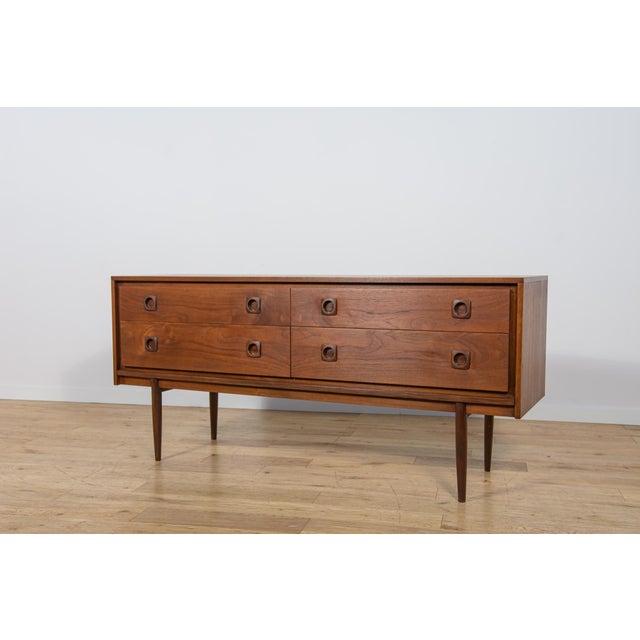 A small dresser manufactured in the 1960s in Great Britain at the Wrighton factory. The dresser consists of four drawers...
