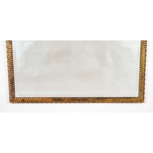 French Art Deco bronze mirror circa 1925. The frame with chisel marks and scalloped edges make this a compelling mirror...