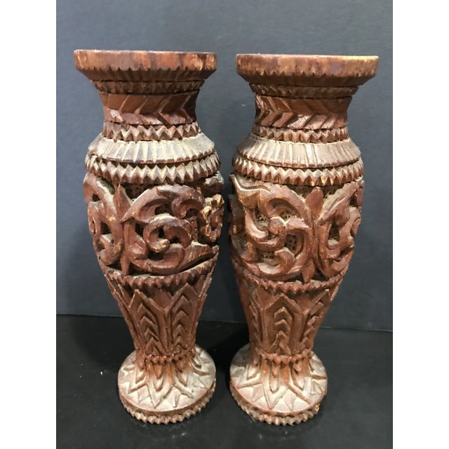 Here are one Indian rosewood silver inlaid box and a pair carved Indian wooden vases set. The vases has some nice floral...