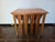 A 1960s set of teak round nesting tables. The Four folded tops pull out make round tables. They slide into a wooden track...