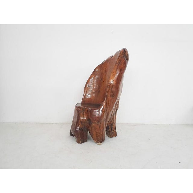 About this item Solid wooden chair carved out of a tree trunk. In a high gloss finish. The chair has a wooden plate under...