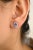 These exquisite stud earrings showcase natural oval-cut tanzanite, each surrounded by a stunning halo of diamonds. The...