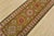 A tribal Caucasian Kazak runner hand-knotted with fine wool on a cotton foundation. This rug features a row of geometric...