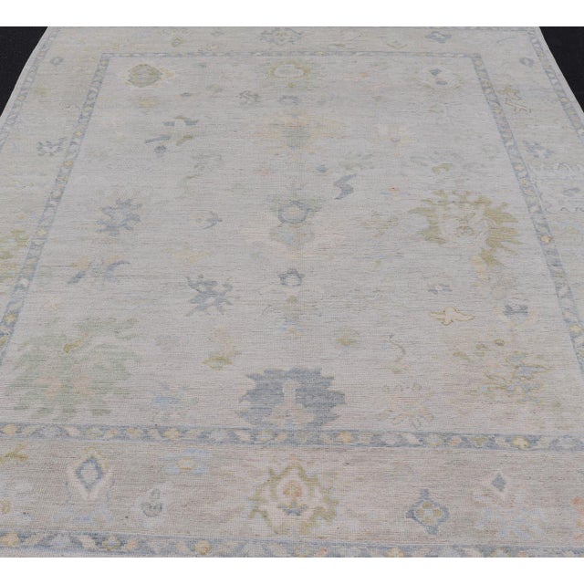 Modern Tribal Oushak with a Cream Border and Light Gray-Blue Background. Country of Origin: Afghanistan; Type: Oushak;...